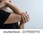 Small photo of women elbow pain, holding hand to spot of elbow pain. Arm pain and injury concept