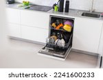 Small photo of Dishes and cutlery on dishwashing machine. Clean dishes