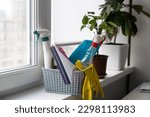 detergents, basket with cleaning supplies in home.