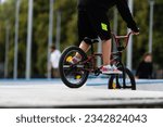 Small photo of boy riding dirtbike at the skate park