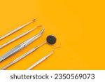 Small photo of Professional Dentist tools in dental office: dentist mirror, forceps curved, explorer curved, dental explorer angular and explorer curved with chip, right. Dental Hygiene and Health