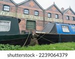 Small photo of Stone, Staffordshire, England, December 1st 2022. Joule's Crown Wharf Brewery against narrowboats, industrial, travel and property editorial illustration.
