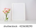 White frame mockup with pink roses. Frame mockup. White frame mockup. Poster product design styled mockup. Empty frame mockup. 