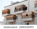 Small photo of View of a residential building in Israel during Sukkot, in which temporary, wooden structures are placed on balconies as part of the ritual observance of the weeklong Jewish holiday.
