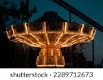 Small photo of Sandusky, Ohio, United State - Aug 2022 - Light of the Wave Swinger at night at Cedar Point