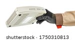 Small photo of Hand of IT-specialist in black protective glove and brown uniform holding VoIP gateway isolated on white background