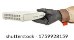 Small photo of IT-specialist hand in black protective glove holding VoIP gateway isolated on white background