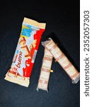 Small photo of Kinder bueno chocolate candy bar on white,black background. Kinder bueno by Italian confectionery manufacturer ferrero