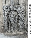 Small photo of A defaced statue of a deity in an ancient Hindu temple