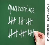 Small photo of inscription quarantine on a blackboard with chalk. strikethrough strikethrough. count days, cross out days
