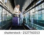 Small photo of mother and daughter at the station go down the escalator to the platform
