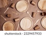 Small photo of Flat lay composition with eco-friendly tableware on brown paper background. Bamboo plates, paper cups and wooden cutlery. Zero waste, plastic free, biodegradable, disposable tableware. Top view.