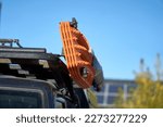 Close up of Two sets of Orange Recovery tracks, boards, ladders mounted on an angle not the roof rack on an off-road 4x4 for use on slippery surfaces like snow, mud or sand
