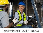 Small photo of Happy female engineer driving and operating on forklift truck in the industry factory. Woman technician wear safety helmet, glasses and uniform working and driving forklift truck