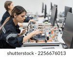 Small photo of Team female engineer training Programmable logic controller with AI robot training kit and mechatronics engineering in the laboratory room