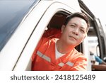 Small photo of Asian male ambulance staff member in his ambulance car. He is wearing ambulance uniform of paramedics during sitting with paramedics giving injured person first aid background