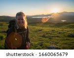 Open landscape of Midnight sun in Lapland Northern Sweden, Europe. Happy Female Hiker enjoy the Midnight Sun north of the Arctic Circle.