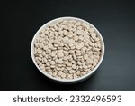 lupin dry beans in a white plate on a black background
