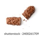 Two halves of a cut chocolate bar with crispy wafers, rice balls and caramel on a white background, top view. Pastry shop concept.