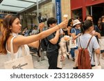 Small photo of New York NY USA-July 13, 2023 Ice cream lovers wait on line at the grand opening of a Van Leeuwen ice cream store in the West Village. The multitude got to purchase a cone or cup for $1.00