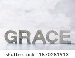 Word GRACE made with cement letters on grey marble background. Copy space. Biblical, spiritual or christian reminder.