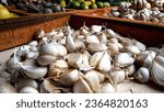 Small photo of Close up of fresh garlic on sale at a vegetable seller's table in a traditional market, one of the healthiest spices.