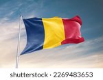 Waving flag of Chad in beautiful sky. Chad flag for independence day. The symbol of the state on wavy fabric.