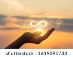 The concept of unlimited Internet. Hand shows the sign of infinity in the sun.