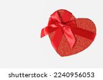 Red heart-shaped box for Valentine's Day, with white background to give as a gift.
