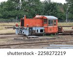 Small photo of Orange pull train standing on a railway sidetrack