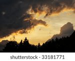 Small photo of minatory clouds of a thunderstorm with bright sun