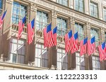 Many flags on the facade of The Saks Fifth Avenue department store in Midtown Manhattan in New York,USA