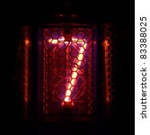 Small photo of The real Nixie tube indicator of the numbers of retro style. Indicator glow with a magical purple fringing. Digit 7