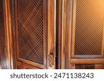 Open wooden door with grating...