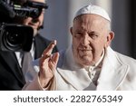 Small photo of VATICAN CITY, VATICAN - 29 MARCH 2023: Pope Francis waves as he arrives on his popemobile car to lead his weekly general audience in St. PeterOs square.