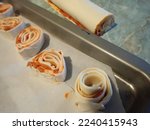 baking homemade pizza rolls from puff pastry in kitchen
