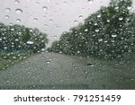 Drizzle on the windshield, Inside car when rainning, Road view through car window with rain drops.