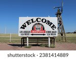 Small photo of Adrian, Texas, USA; October 25 2023: Midway point of historic old Route 66 between Chicago and Los Angeles (both 1139 miles). Welcome sign near the road.
