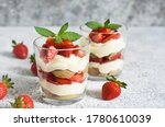 Strawberry tiramisu in a glass on a concrete background. Classic Italian dessert.