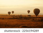 Air balloons during sunrise above Masai Mara in Kenya. 