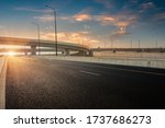 Dusk colored clouds in the background, highway overpass curved approach bridge 