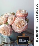 Small photo of easter pink bombastic roses and chalkboard with Easter text on it