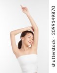 Small photo of Beautiful Young Asian woman lifting hands up to show off clean and hygienic armpits or underarms on white background, Smooth armpit cleanliness and protection concept.