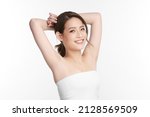 Small photo of Beautiful Young Asian woman lifting hands up to show off clean and hygienic armpits or underarms on white background, Smooth armpit cleanliness and protection concept.