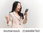 Small photo of Portrait photo of young beautiful Asian woman feeling happy or surprise shock and holding smart phone with black empty screen on white background can use for advertising or product presenting concept.