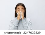 Asian woman holding hand with handkerchief and coughing up flu and cold, stuffy nose viral disease covid 19 white background