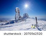 Ski and snowboard background blue sky with sun light frozen rocks, Sheregesh ski resort. Concept extream freeride on fresh snow.