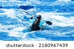 Whitewater kayaking, extreme sport rafting. Young woman in kayak sails mountain river.