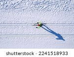 Winter sports competitions, cross country skis glide on fresh snow, aerial top view.
