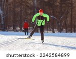 Cross country skiing in winter on snowy track, sunset background, habits for a healthy lifestyle.